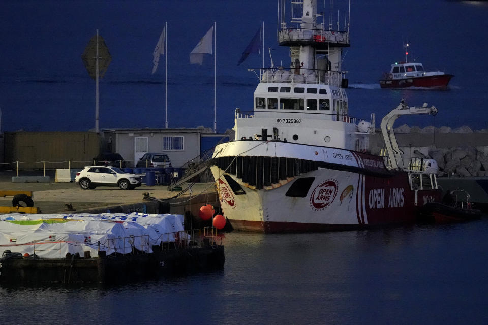 Aid packages are seen left, on a platform near to the docked ship belonging to the Open Arms aid group, as it prepares to ferry some 200 tonnes of rice and flour directly to Gaza, at the port in Larnaca, Cyprus, Sunday, March 10, 2024. The European Commission president said Friday the Open Arms ship will make a pilot voyage as international donors launched a sea corridor to supply the besieged territory that is facing widespread hunger after five months of war. (AP Photo/Petros Karadjias)