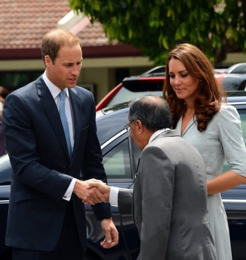 Britain's Prince William (left) shakes hand with Richard Robless, council member of Hospis Malaysia, upon arrival with his wife Catherine, the Duchess of Cambridge, in Kuala Lumpur on September 13. Britain's younger royals are touring the globe throughout 2012 as part of celebrations marking the 60-year reign of William's grandmother, Queen Elizabeth II