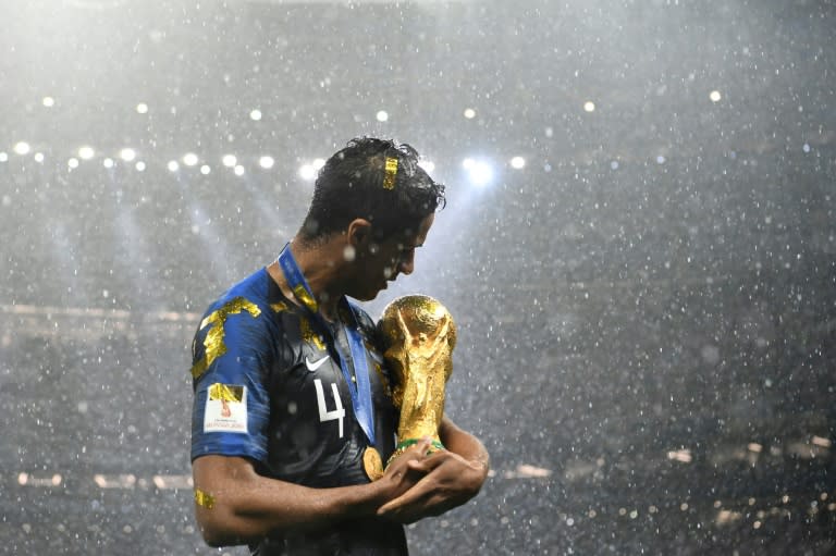 France defender Raphael Varane cradled the World Cup trophy in Moscow's Luzhniki Stadium after the victory