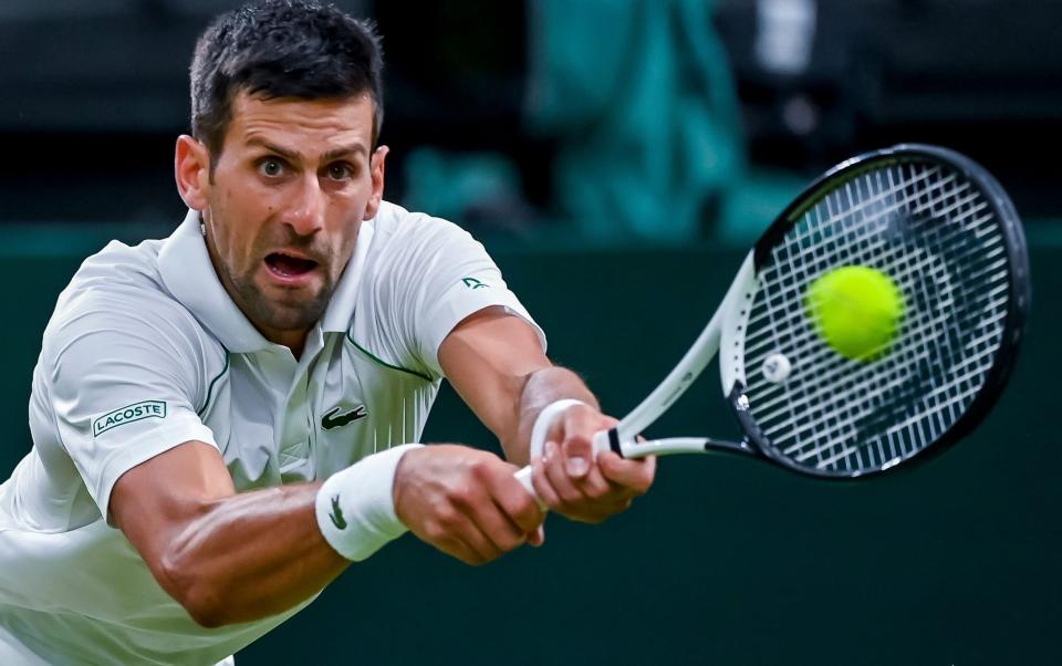 Novak Djokovic returns the ball - SHUTTERSTOCK