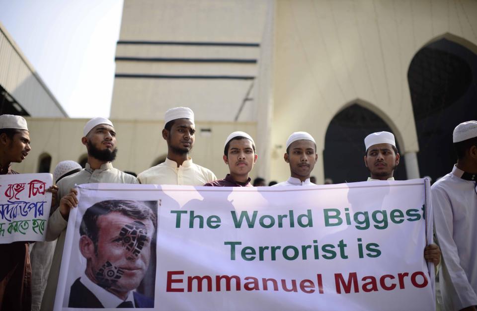 Supporters of Islami Oikya Jote, an Islamist political party, protest against the publishing of caricatures of the Prophet Muhammad they deem blasphemous, in Dhaka, Bangladesh, Wednesday, Oct. 28, 2020. Muslims in the Middle East and beyond on Monday called for boycotts of French products and for protests over the caricatures, but French President Emmanuel Macron has vowed his country will not back down from its secular ideals and defense of free speech. Posters read "France is the enemy of humanity. World citizens fight back." second left, "Muslims of the world stand against insults to the prophet," third right and "Stop buying products from France. In the name of the Prophet," left. (AP Photo/Mahmud Hossain Opu)