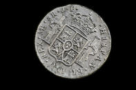 A silver coin from the shipwreck of a 1804 galleon, on its first display to the media at a ministry building, in Madrid, Friday, Nov. 30, 2012. Spanish cultural officials have allowed the first peep at 16 tons (14.5 metric tons) of the shipwreck, 'Nuestra Senora de las Mercedes' a treasure worth an estimated $500 million that a U.S. salvage company gave up after a five-year international ownership dispute. (AP Photo/Daniel Ochoa de Olza)