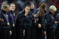 Carli Lloyd #10 of the United States kisses her gold medal as Heather O'Reilly #9 looks on after defeating Japan by a score of 2-1 to win the Women's Football gold medal match on Day 13 of the London 2012 Olympic Games at Wembley Stadium on August 9, 2012 in London, England. (Getty Images)