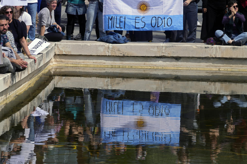 An Argentinian flag with the message 'Milei is hatred' is held during an anti-fascist demonstration as far-right party Vox members gather in Madrid with Argentina's president Javier Milei and others far-right European leaders, in Madrid, Spain, Sunday, May 19, 2024. (AP Photo/Paul White)