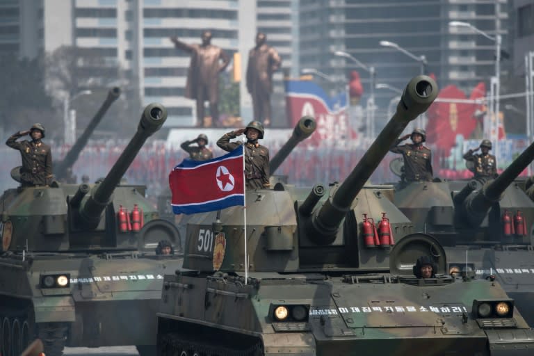 North Korean leader Kim Jong-Un took the salute as ranks of goose-stepping soldiers followed by tanks and military hardware paraded in Pyongyang in a show of strength