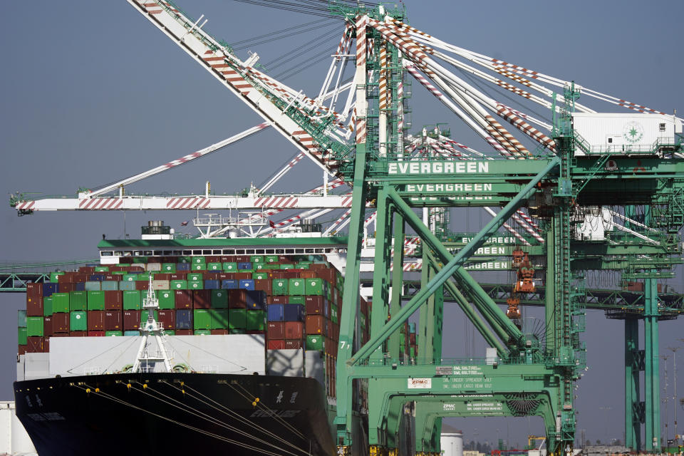 A cargo ship stacked with shipping containers is docked at the Port of Los Angeles Wednesday, Nov. 10, 2021, in Los Angeles. Experts say unless more spending shifts back to services or something else motivates people to stop buying, it could take well into next year or even 2023 before the U.S. and global supply chains return to some semblance of normal. (AP Photo/Marcio Jose Sanchez)