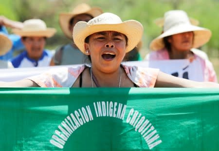 A woman shouts during the 10th Indigenous March to defend Mother Earth, sign reads "Chiquitania Indigenous Organization", near San Jose