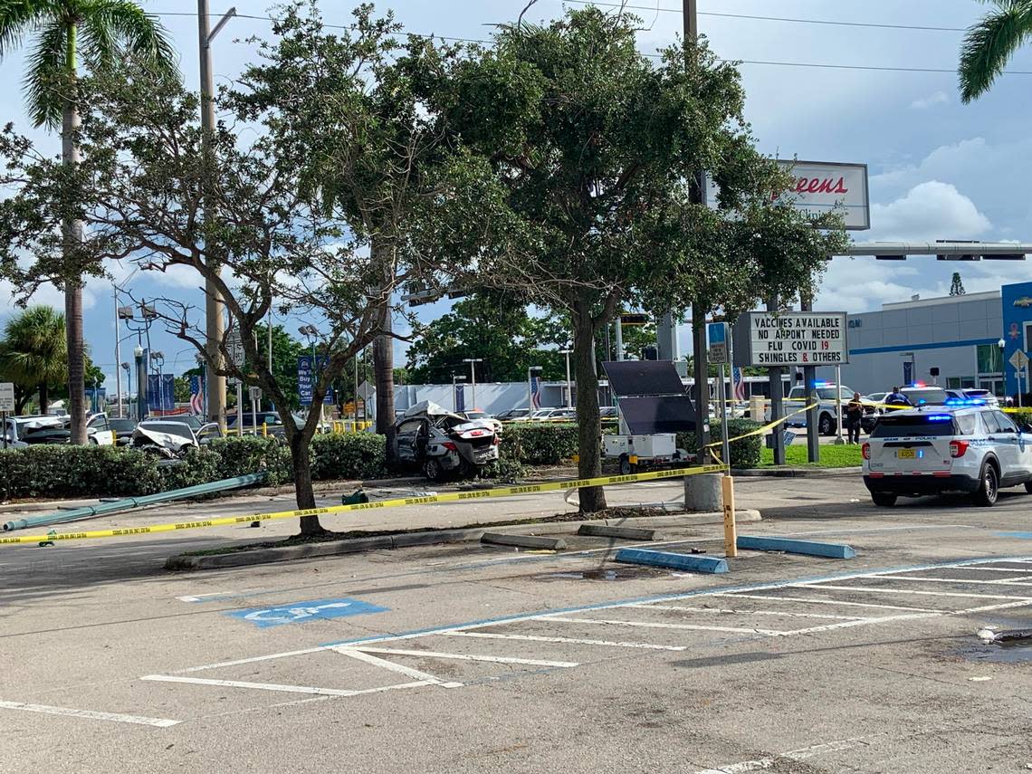 The SUV, the two sedans and a Miami police vehicle during the investigation of the three-car crash at Southwest 42nd Avenue and Eighth Street.