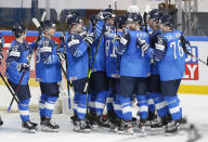 Finland's players celebrate their 1-0 victory in the Ice Hockey World Championship quarterfinal match between Finland and Czech Republic at the Arena in Riga, Latvia, Thursday, June 3, 2021. (AP Photo/Sergei Grits)