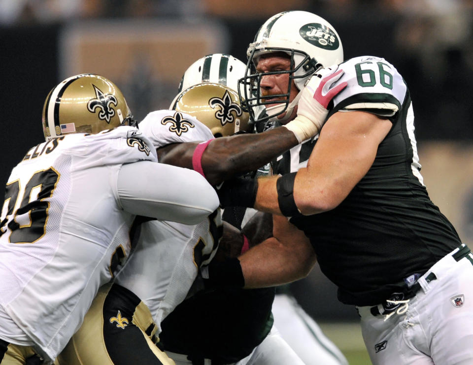 FILE - New York Jets guard Alan Faneca (66) blocks New Orleans Saints defensive tackle Sedrick Ellis, left, and defensive end Bobby McCray, center, in the first half of an NFL football game in New Orleans, Oct. 4, 2009. Faneca played 10 years with Pittsburgh, helping the Steelers win a Super Bowl while also becoming one of the NFL’s top guards as a ferocious run blocker. The six-time All-Pro signed a five-year deal with the Jets in 2008, helping them make the AFC title game that season. (AP Photo/Bill Feig, File)