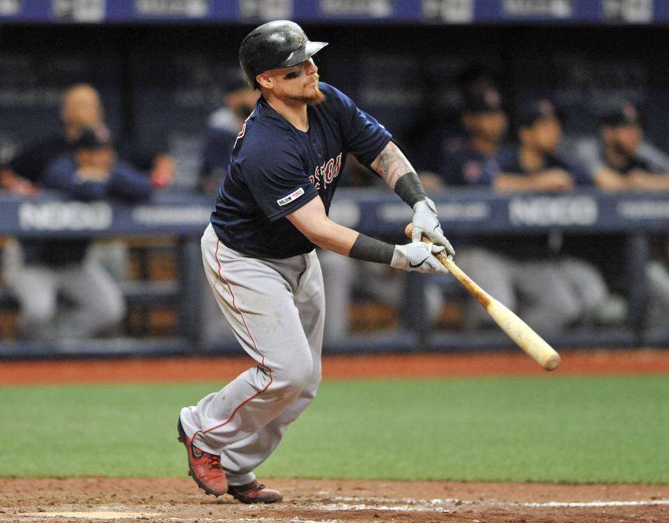 Boston Red Sox's Christian Vazquez hits a sacrifice fly ball to center field to knock in the game-winning run off Tampa Bay Rays reliever Jose Alvarado during the 11th inning of a baseball game Sunday, April 21, 2019, in St. Petersburg, Fla. The Red Sox beat the Rays 4-3. (AP Photo/Steve Nesius)