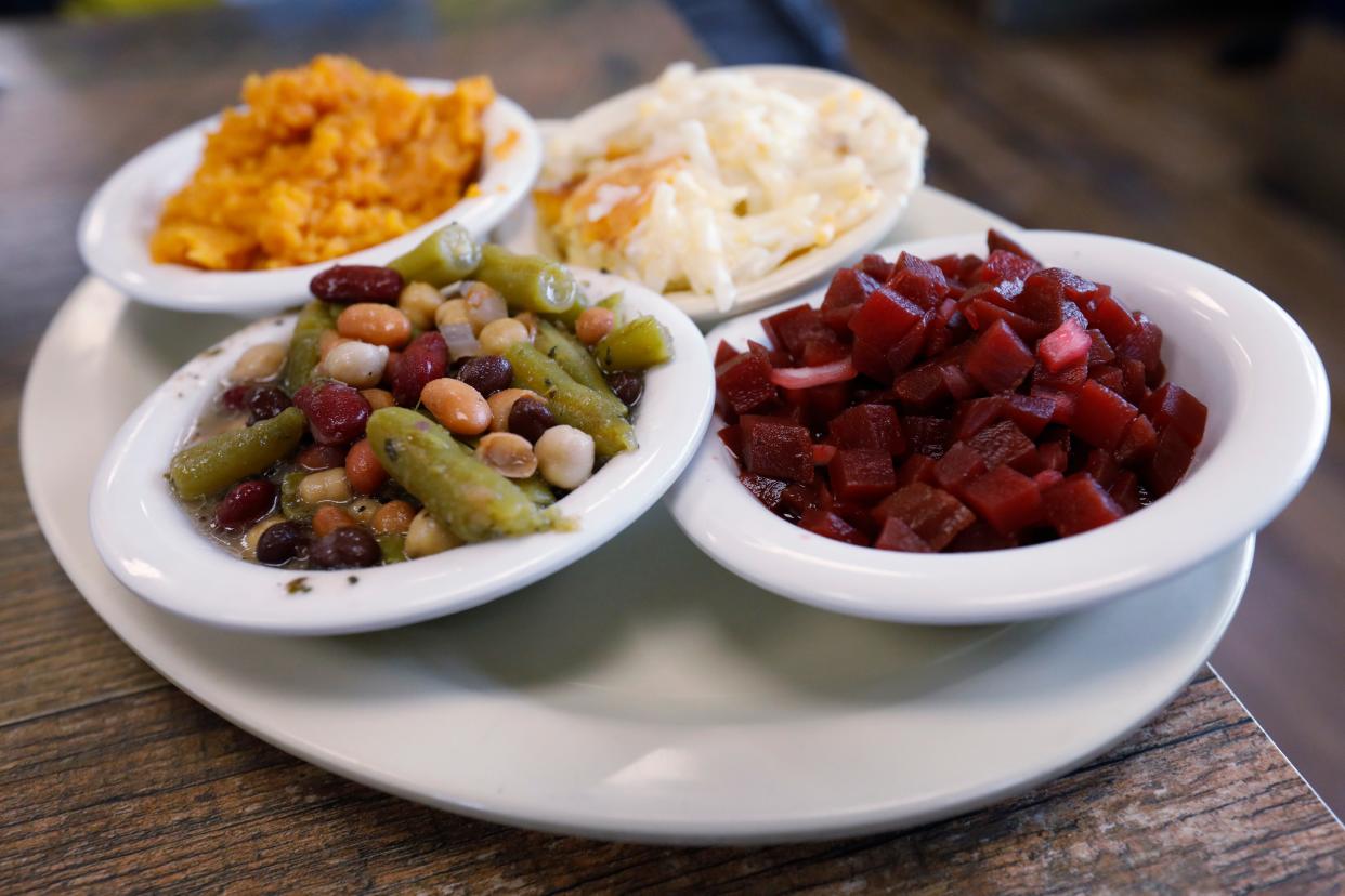 The veggie plate with beet salad, bean salad, hash browns casserole and carrot soufflé at Rachel's Southern Style Restaurant at lunch time in Watkinsville, Ga., on Thursday, July 25, 2024. Rachel's changes up its vegetables daily featuring all the southern classics.