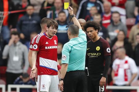 Britain Football Soccer - Middlesbrough v Manchester City - Premier League - The Riverside Stadium - 30/4/17 Middlesbrough's Marten de Roon is shown a yellow card by referee Kevin Friend after conceding a penalty while Manchester City's Leroy Sane looks on Reuters / Russell Cheyne Livepic