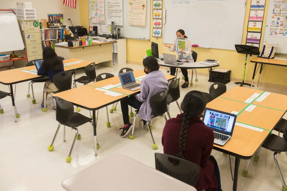 Fourth-graders at Hesse K-8 School, both in-person and online, listen as ESOL teacher Cherie Goldman reads Verdi, a story about a young python who can't fathom why adult pythons are so lazy and boring, on Monday, May 17.
(Credit: Will Peebles/For Savannah Morning News)