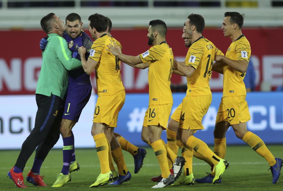 Australian players celebrate after scoring the winning penalty in a shootout at the end of the AFC Asian Cup round of 16 soccer match between Australia and Uzbekistan at the Khalifa bin Zayed Stadium in Al Ain, United Arab Emirates, Monday, Jan. 21, 2019. (AP Photo/Kamran Jebreili)