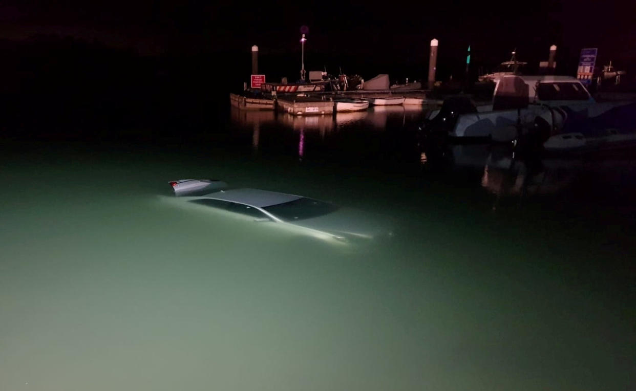 The car in the water after reversing down a boat launch in the New Forest in February.See SWNS story SWBRcar. A driver had a miracle escape after he accidentally reversed down a boat launch - landing fully submerged in the water. Police say the motorist was 