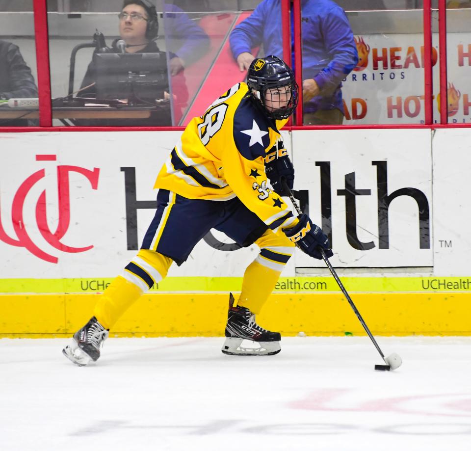 A.J. Luzi, shown moving the puck against St. Xavier in January, was voted Cincinnati.com hockey player of the week for the boys winter team of the week, Moeller ice hockey.