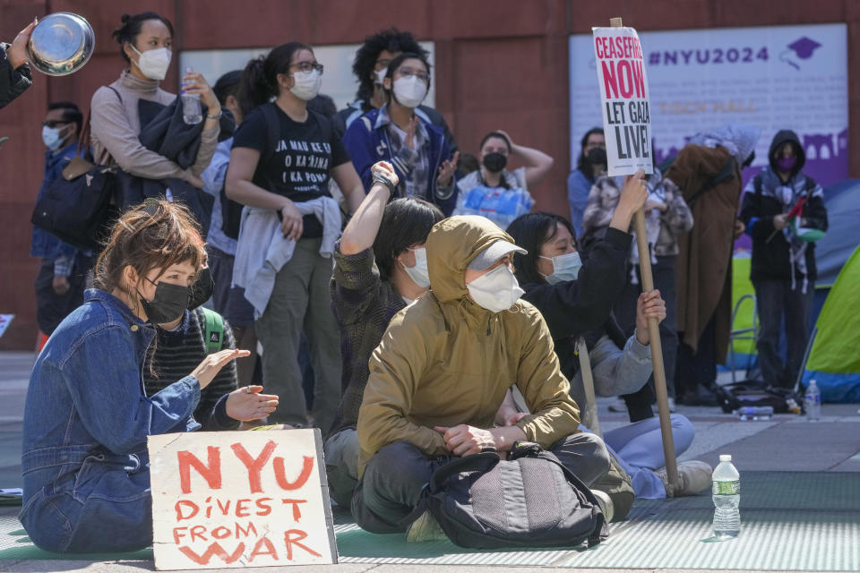 FILE - New York University students and pro-Palestinian supporters rally outside the NYU Stern School of Business building, Monday, April 22, 2024, in New York. Some NYU students facing discipline for their actions during this spring's pro-Palestinian protests have been assigned a 49-page workbook that includes a "Simpsons"-based module on ethical decision making. Some have been asked to write an apologetic "reflection paper" and submit it "in 12-point Times New Roman or similar font."(AP Photo/Mary Altaffer, File)