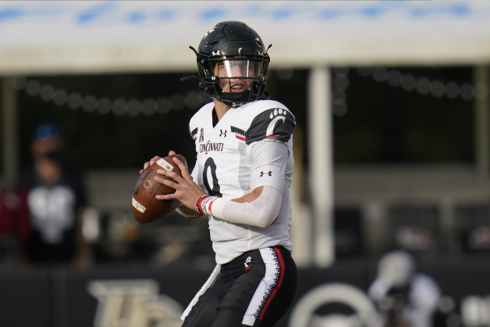 Cincinnati quarterback Desmond Ridder looks for a receiver against Central Florida during the first half of an NCAA college football game, Saturday, Nov. 21, 2020, in Orlando, Fla. (AP Photo/John Raoux)