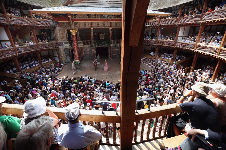 A view from the crowd as they watch a performance of a Shakespearian play. The set up would have been similar to one seen some 400 years ago when the plays were first performed.