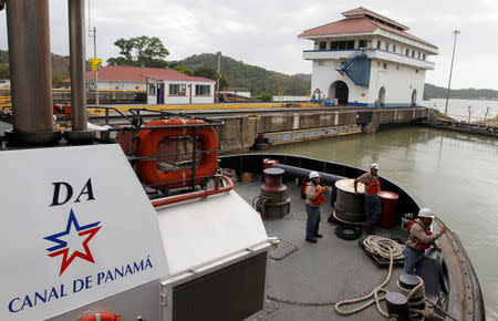 FILE-PHOTO: Employees are seen in a tugboat at the Pedro Miguel lock on the pacific side of the Panama Canal in Panama City January 28, 2013. REUTERS/Carlos Jasso/File Photo
