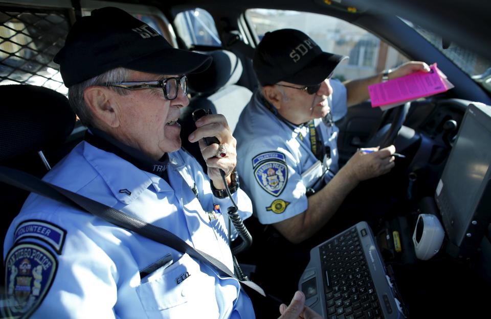 Dick Engel (L) calls into police dispatch as he and partner Ed Robles respond to an accident during their patrol as members of the Retired Senior Volunteer Patrol in San Diego, California, United States February 4, 2015. When you think of a police car patrolling the streets of a U.S. city, the first thing that comes to mind may not be an 88-year-old World War II veteran teamed up with a pilot from the Vietnam war – unless you are travelling through San Diego, California. The Retired Senior Volunteer Patrol, former airline pilots, paramedics or military personnel among them, spot stolen vehicles and help free up regular serving officers. In the process the unarmed recruits often get a new lease of life after finding a more sedate retirement didn’t suit them. (REUTERS/Mike Blake)