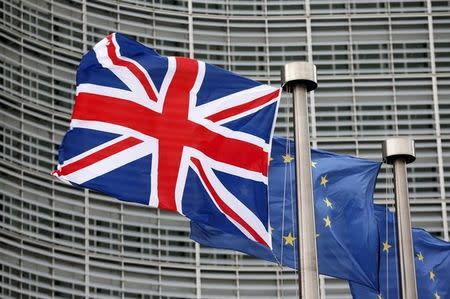 A Union Jack flag flutters next to European Union flags ahead of a visit from Britain's Prime Minister David Cameron at the EU Commission headquarters in Brussels, Belgium, January 29, 2016. REUTERS/Francois Lenoir