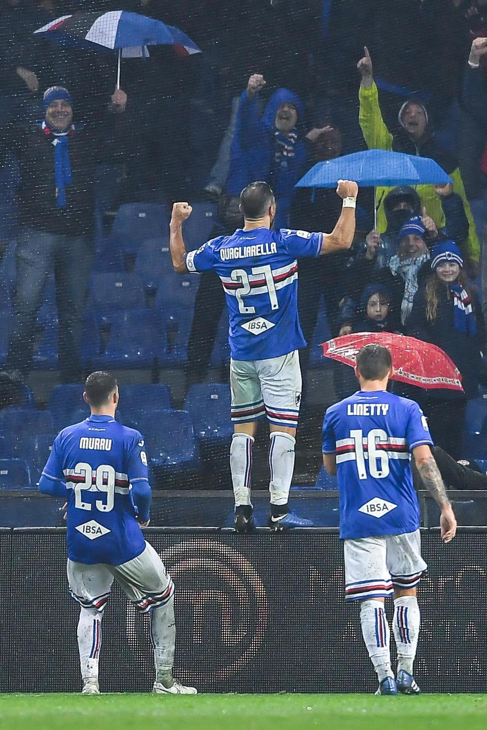 Sampdoria's Fabio Quagliarella, center, climbs up on advertising boards and celebrates in front of fans after scoring his team's second goal during the Italian Serie A soccer match between Sampdoria and Parma at the Luigi Ferraris stadium in Genoa, Italy, Sunday, Dec. 16, 2018. (Simone Arveda/ANSA via AP)