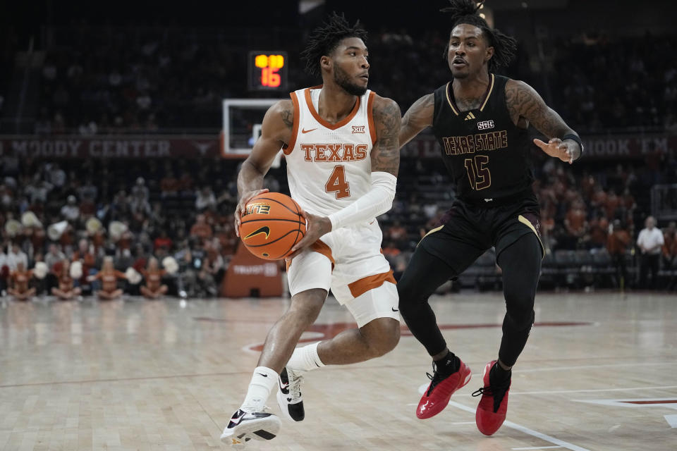 Texas guard Tyrese Hunter (4) drives around Texas State guard Elijah Tate (15) during the second half of an NCAA college basketball game in Austin, Texas, Thursday, Nov. 30, 2023. (AP Photo/Eric Gay)