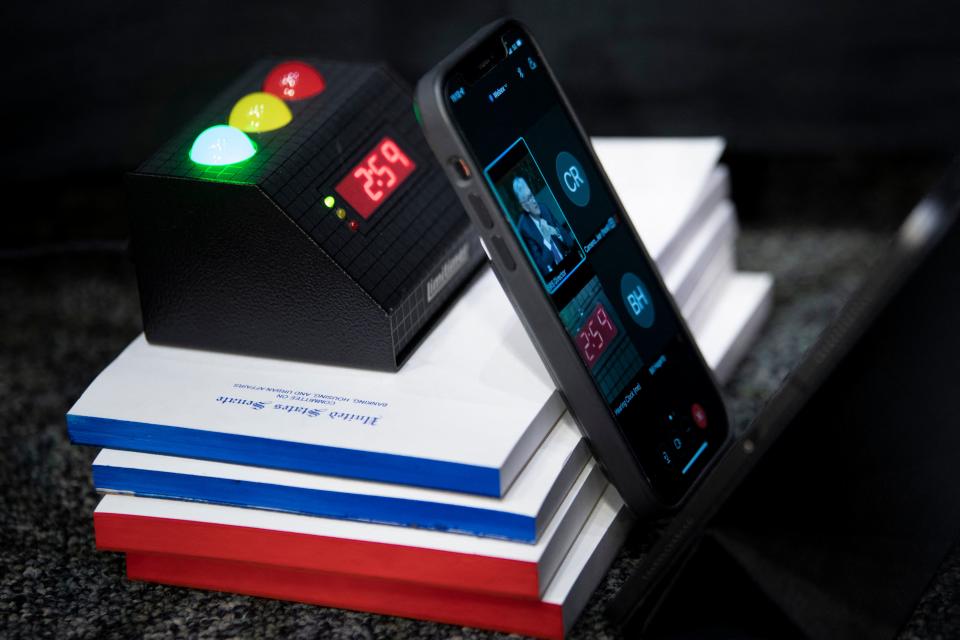 A phone is used for virtual attendees of Federal Reserve Board Chairman Jerome Powell re-nominations hearing of the Senate Banking, Housing and Urban Affairs Committee  on Capitol Hill January 11, 2022, in Washington, DC. (Photo by Brendan Smialowski / POOL / AFP) (Photo by BRENDAN SMIALOWSKI/POOL/AFP via Getty Images)