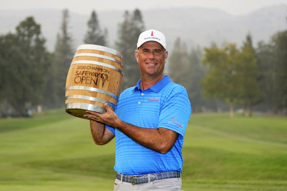 Stewart Cink poses with his trophy on the 18th green of the Silverado Resort North Course after winning the Safeway Open PGA golf tournament Sunday, Sept. 13, 2020, in Napa, Calif. (AP Photo/Eric Risberg)