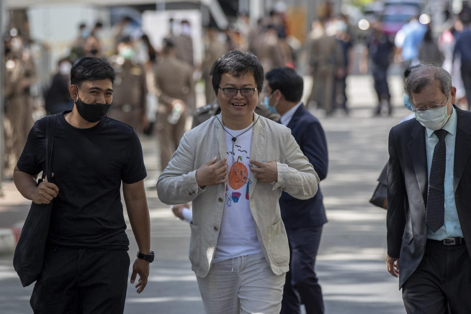 Pro-democracy activist and human rights lawyer Arnon Nampha, center, arrives at criminal courthouse for hearing to determine whether he has violated his bail conditions in Bangkok, Thailand, Thursday, Sept. 3, 2020. Growing pro-democracy protests have emerged as the most serious threat to the government led by a former army general accused of incompetence and corruption by protesters. (AP Photo/Gemunu Amarasinghe)