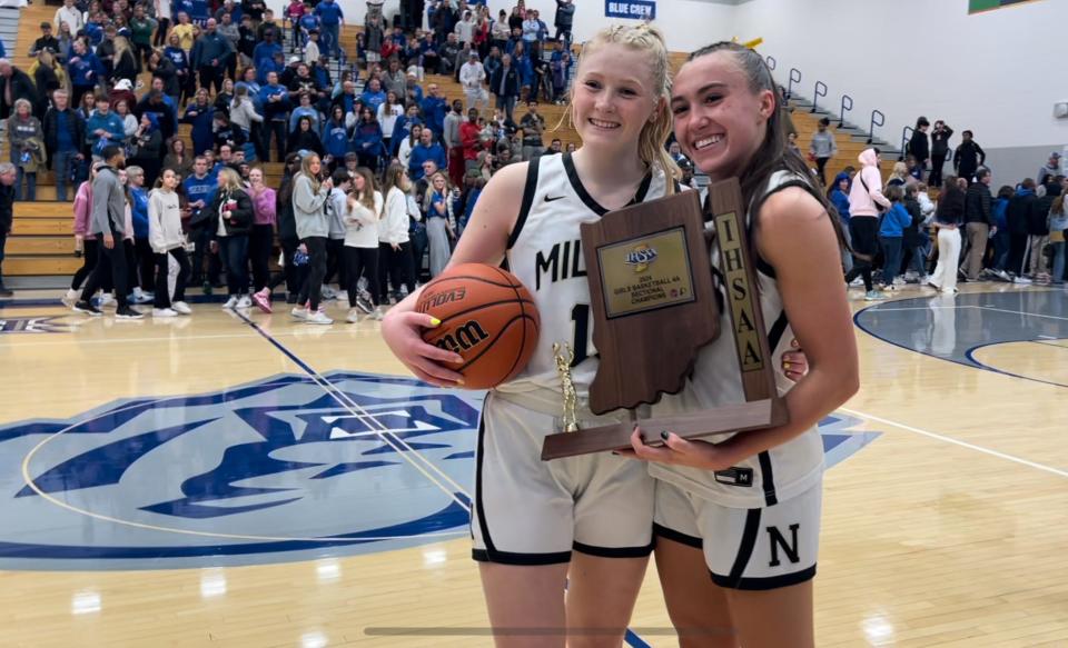 Noblesville seniors Ava Shoemaker (left) and Reagan Wilson pose with the sectional championship trophy following the Millers' win over Hamilton Southeastern on Feb. 3, 2024.