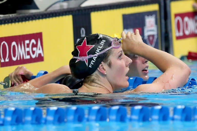 Missy Franklin of the United States reacts with Kathleen Baker of the United States after competing in a preliminary heat for the Women's 100 Meter Backstroke during Day 2 of the 2016 U.S