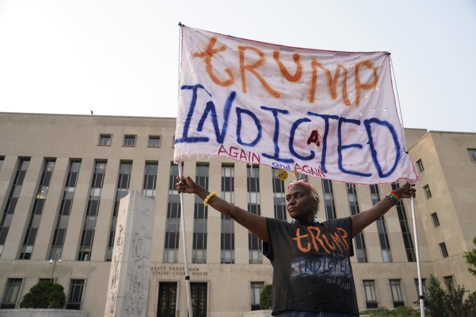 Aug. 1, 2023: Nadine Seiler holds a sign outside the E. Barrett Prettyman United States Courthouse in Washington. Former President Donald Trump was indicted on four charges in the United States District Court for the District of Columbia in relation to interference in 2020 election.