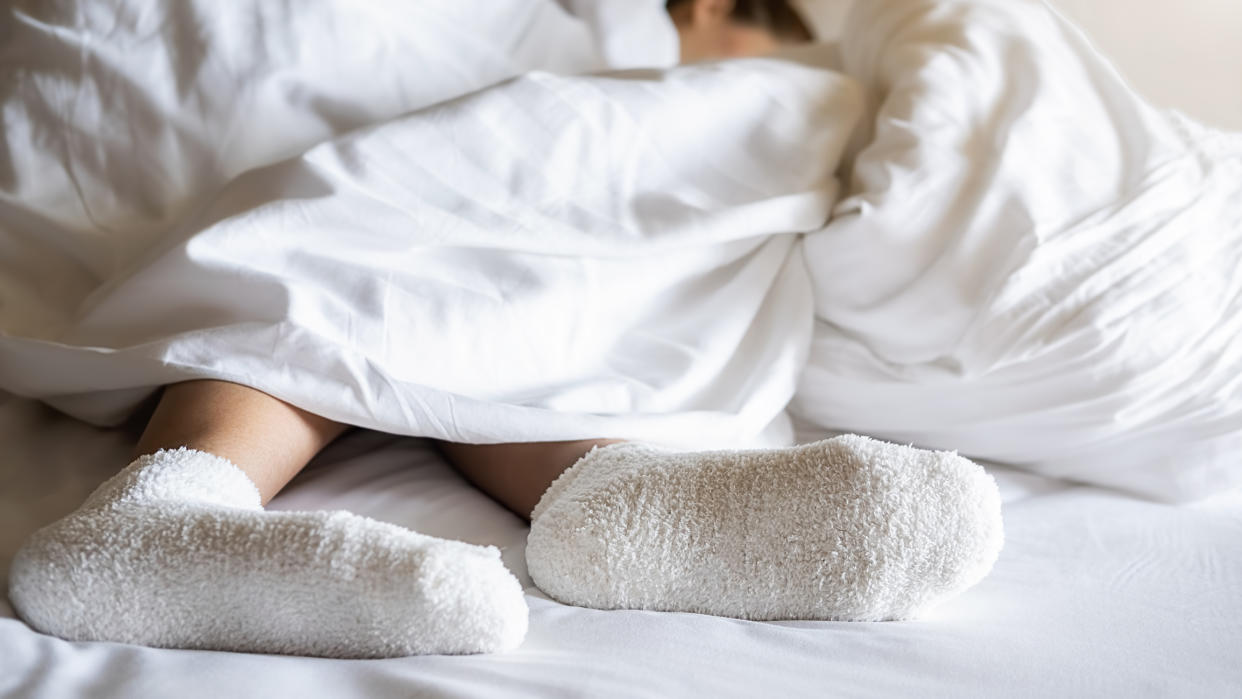 Does wearing socks to bed really help you drift off faster? (Getty Images)