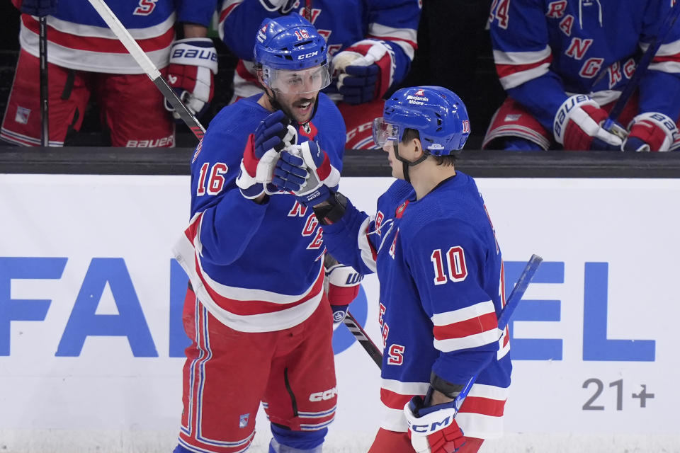 New York Rangers left wing Artemi Panarin (10) celebrates with New York Rangers center Vincent Trocheck (16) after Panarin scored in the second period of an NHL hockey game against the Boston Bruins, Thursday, March 21, 2024, in Boston. (AP Photo/Steven Senne)
