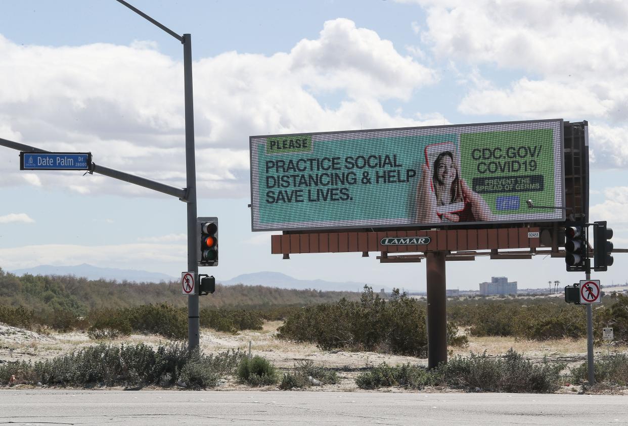 A billboard urges social distancing as the government steps up its coronavirus messaging in Cathedral City, March 23, 2020.