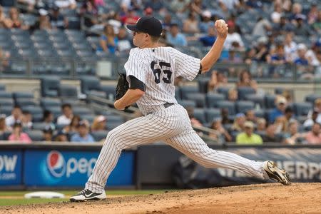 Sep 13, 2015; Bronx, NY, USA; New York Yankees pitcher Caleb Cotham (65) delivers a pitch during the ninth inning of the game against the Toronto Blue Jays at Yankee Stadium. Mandatory Credit: Gregory J. Fisher-USA TODAY Sports