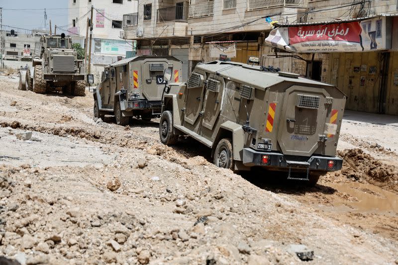 Israeli military vehicles are seen in Jenin