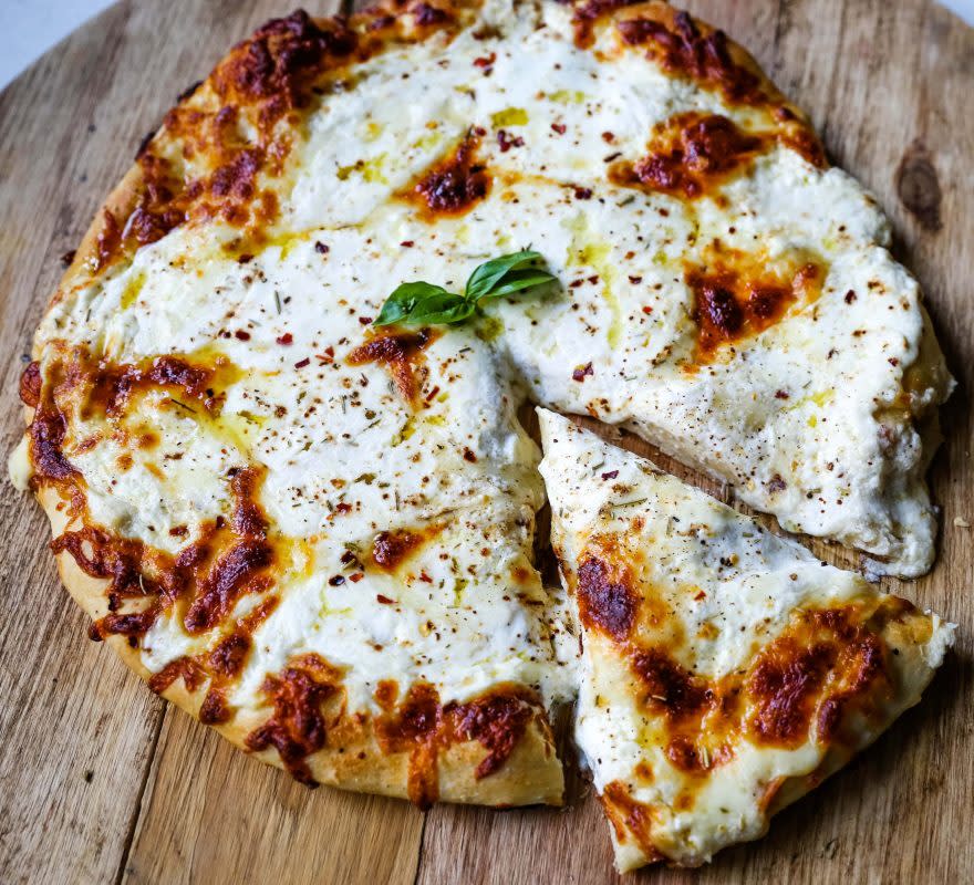 <p>Modern Honey</p><p>A New York-style white pizza with drizzled olive oil, mozzarella, parmesan and ricotta cheese with Italian herbs.</p><p><strong>Get the recipe: <a href="https://www.modernhoney.com/the-best-3-cheese-white-pizza/" rel="nofollow noopener" target="_blank" data-ylk="slk:3-Cheese White Pizza;elm:context_link;itc:0;sec:content-canvas" class="link rapid-noclick-resp">3-Cheese White Pizza</a></strong></p><p><strong>Next: <a href="https://parade.com/food/history-of-pizza" rel="nofollow noopener" target="_blank" data-ylk="slk:No Matter How You Slice It, the History of Pizza Will Surprise You;elm:context_link;itc:0;sec:content-canvas" class="link rapid-noclick-resp">No Matter How You Slice It, the History of Pizza Will Surprise You</a></strong></p>