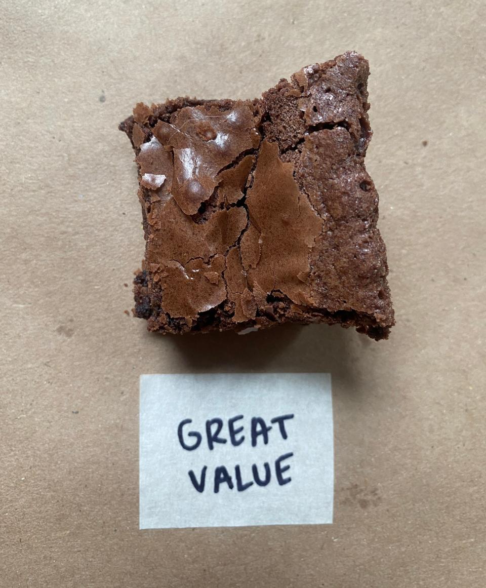 A brownie with sea salt on top next to a label reading 