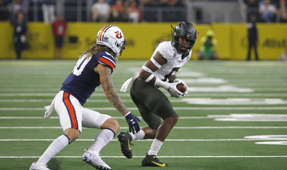 Oregon safety Jevon Holland (8) intercepts a pass in front of Auburn wide receiver Sal Cannella (80) during the first half of an NCAA college football game, Saturday, Aug. 31, 2019, in Arlington, Texas. (AP Photo/Ron Jenkins)