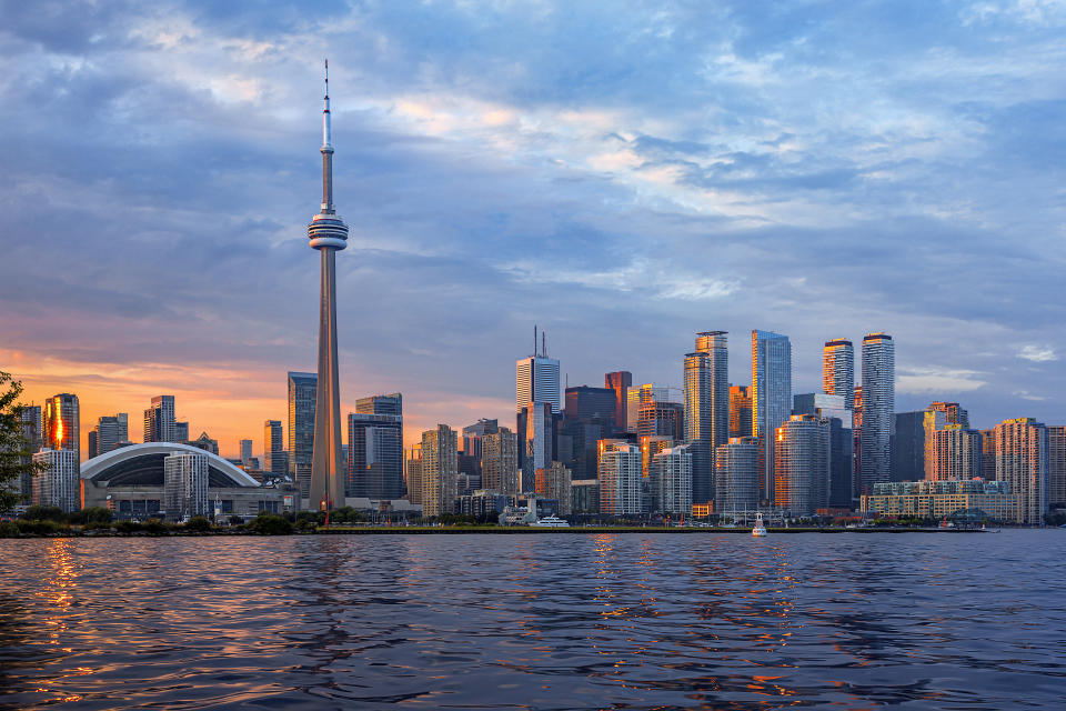 Landmarks of Toronto with the CN Tower, white stadium dome of the Rogers Centre, and the skyscrapers of the downtown business district.