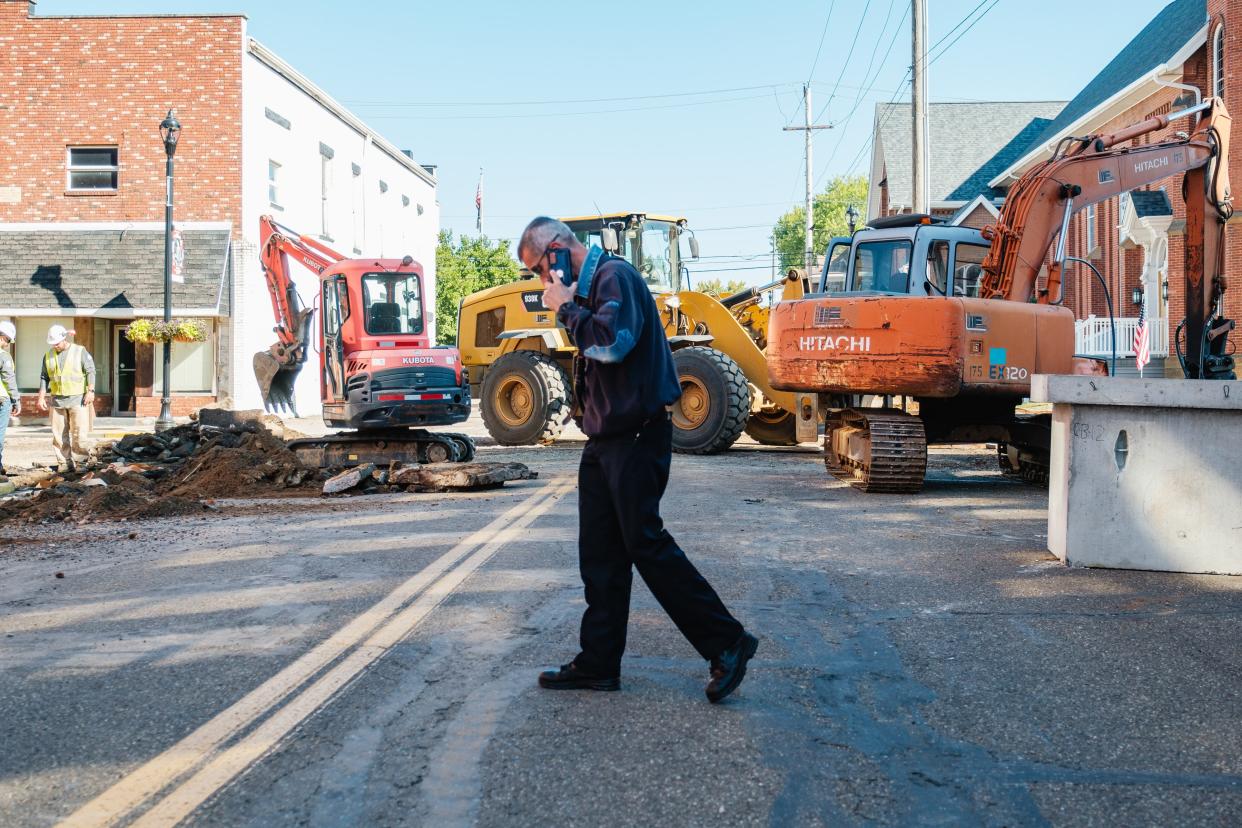 Dennison Fire Department Chief David McConnell talks on his phone at the scene of a ruptured gas line, Tuesday morning.