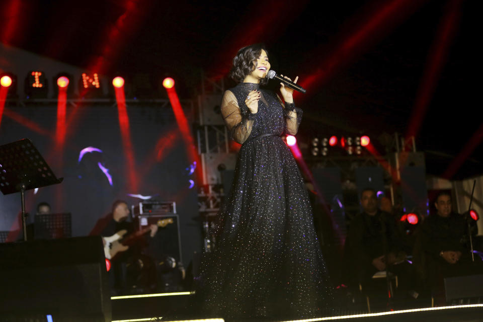 In this Dec. 31, 2018 photo, Egyptian singer Sherine Abdel-Wahab performs during New Years' Eve, in Cairo, Egypt. Abdel-Wahab has been banned from performing in her home country after suggesting that it does not respect free speech. (AP Photo/Mahmoud Abdel Nasser)