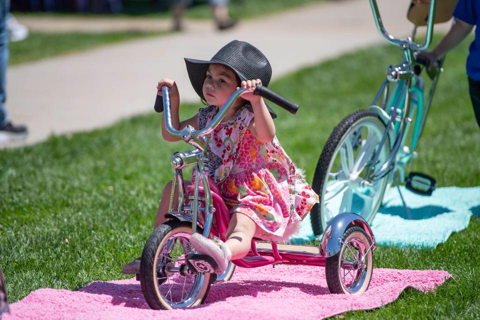 Rosie Chavez, 3, sits on her custom tricyle at the annual Cinco de Mayo celebration at Ray Agilera Park on Friday, May, 5, 2023.