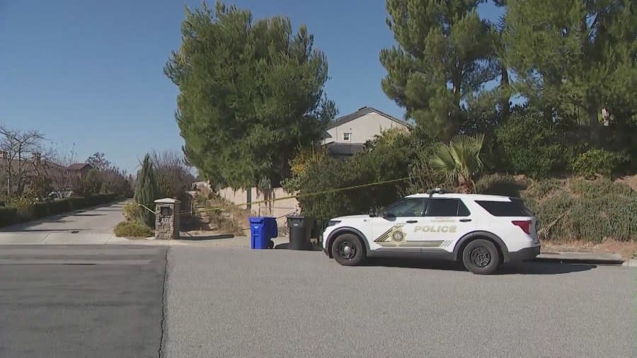 Investigators examine the horse trail next to a home that was used as the escape route by two home invasion suspects on Dec. 12, 2023. (KTLA)