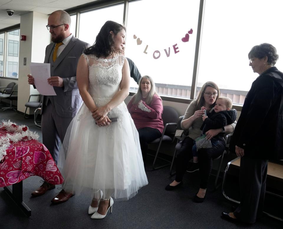 Jordan Myers, left, and Jaimie Scott, right, of the Near East Side, check in to be married in Franklin County Municipal Court on Valentine's Day.