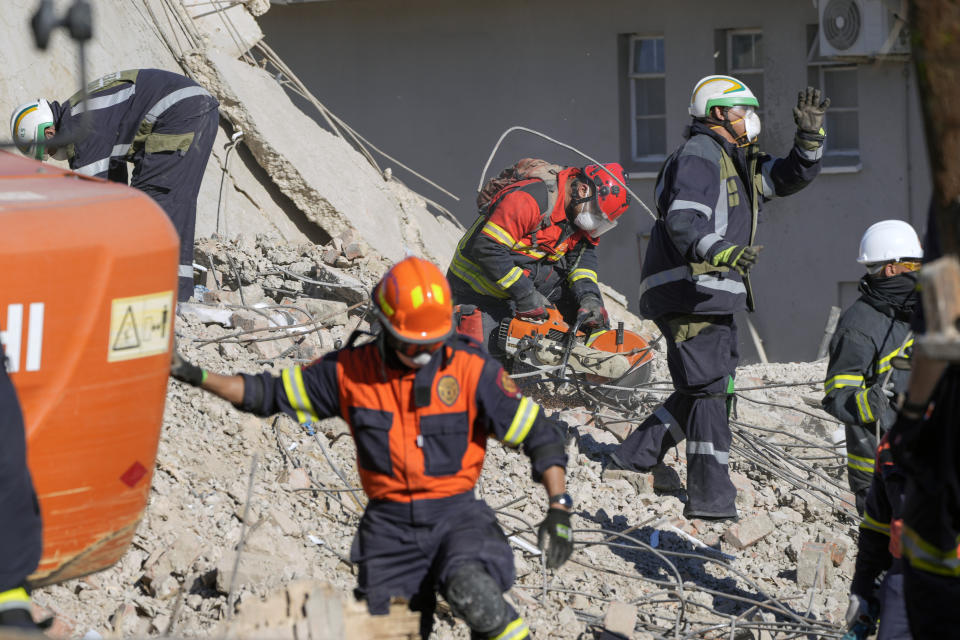 Rescue personnel search the site of a building collapse in George, South Africa, Thursday, May 9, 2024. Rescue teams, searching for dozens of construction workers missing after a multi-story apartment complex collapsed in the coastal city, have not brought out more survivors in the past 24 hours. (AP Photo/Jerome Delay)